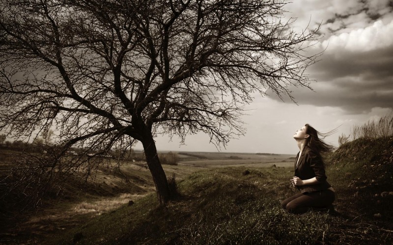 Young beautiful girl emotionally prays to the god of a wind