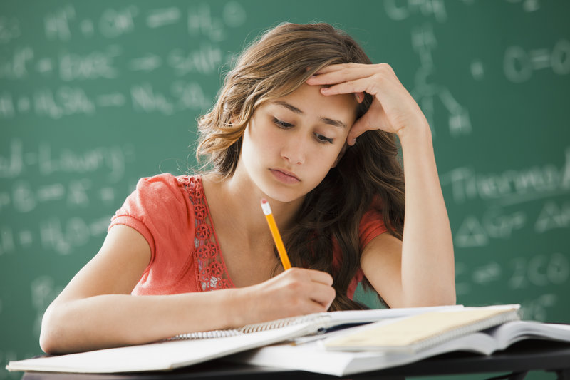 Caucasian teenager studying in classroom