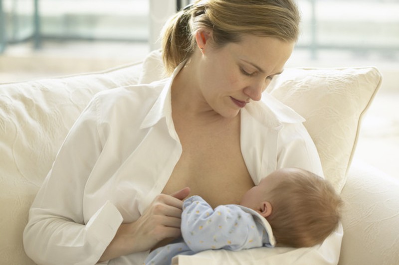 Mother Breast Feeding Newborn Baby --- Image by © Royalty-Free/Corbis