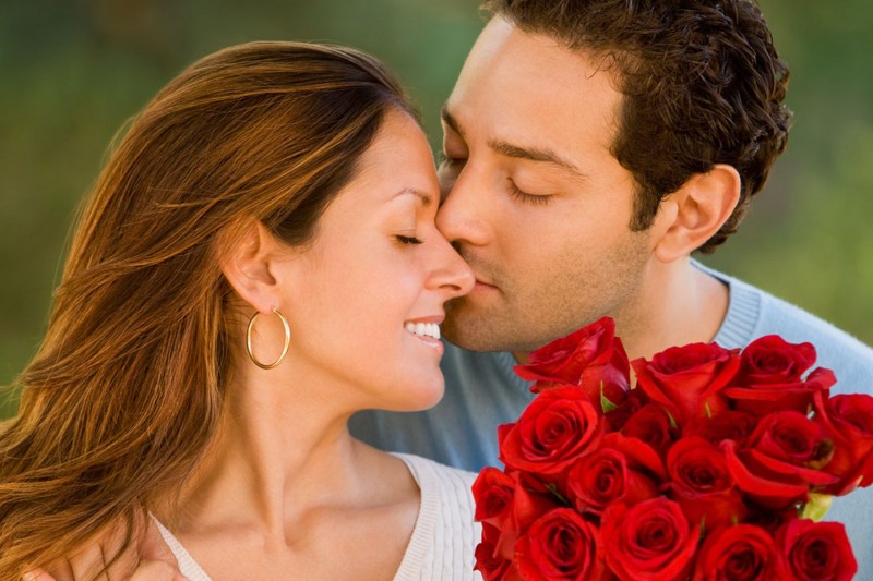 Hispanic-man-giving-flowers-to-wife