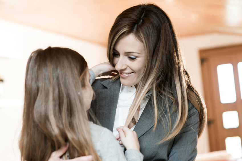 Mother embracing her little girl before leaving to work/or just back from work