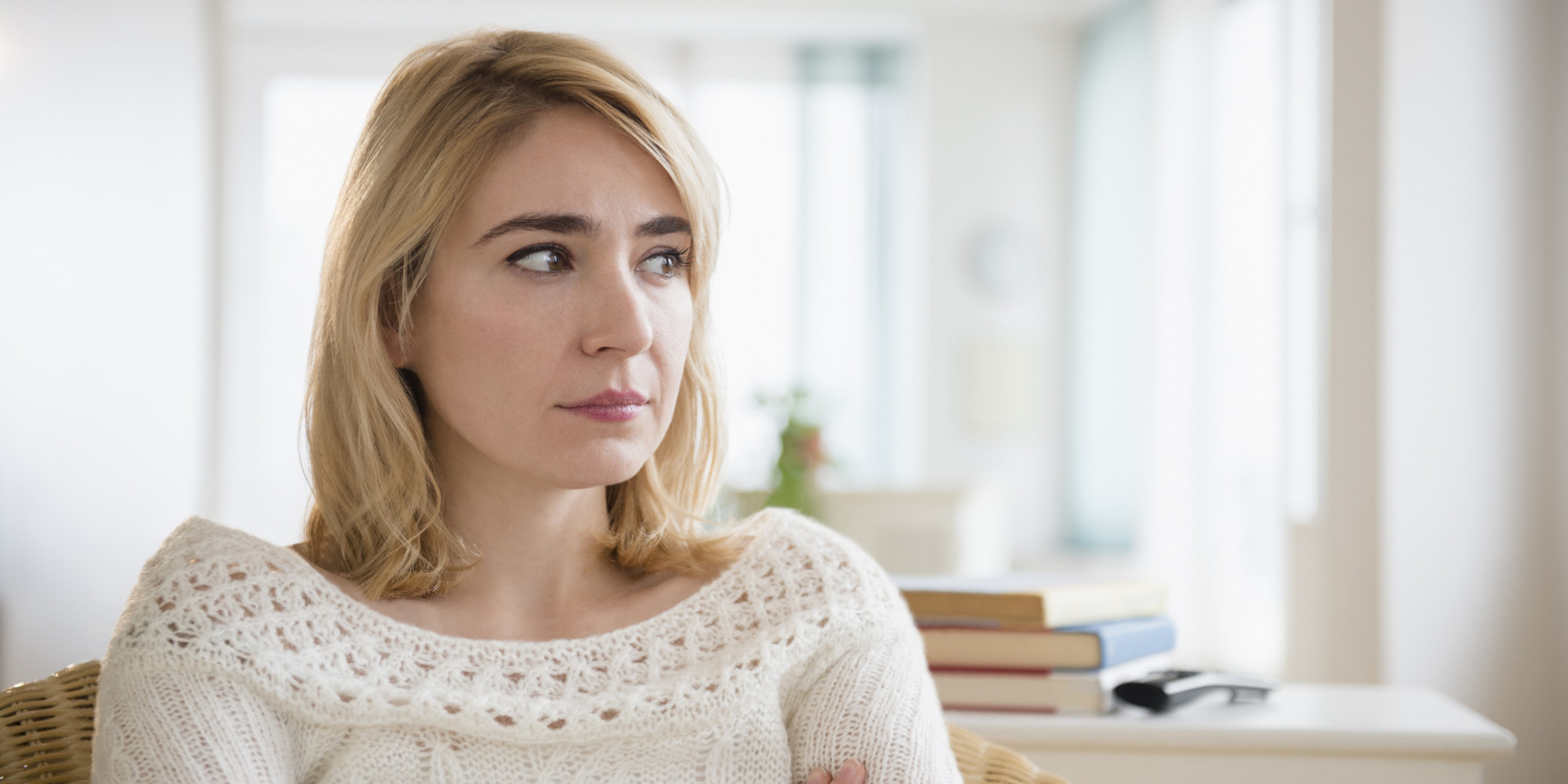 Lonely Caucasian woman sitting in living room