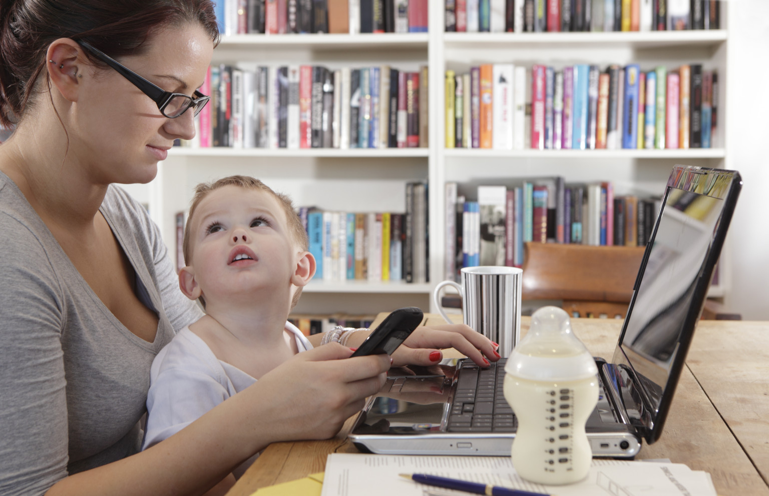 mother working/studying with baby