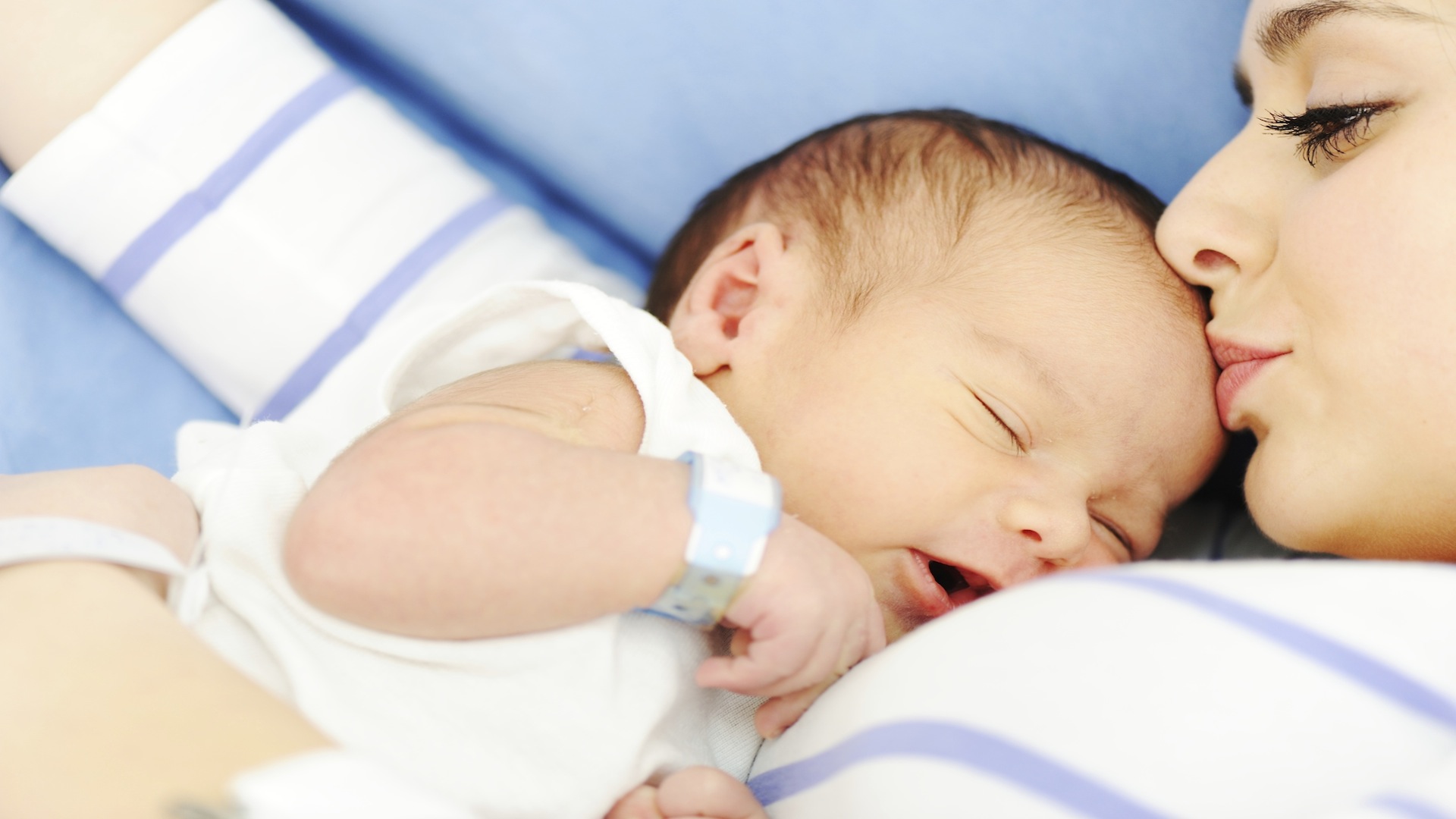 Woman holding her newborn baby at hospital